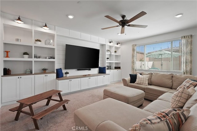 carpeted living room with ceiling fan