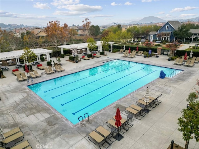 view of pool with a mountain view, a patio area, and a pergola