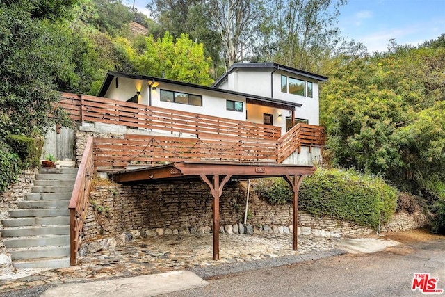 rear view of house featuring a deck