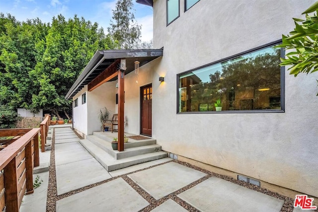 property entrance featuring a patio