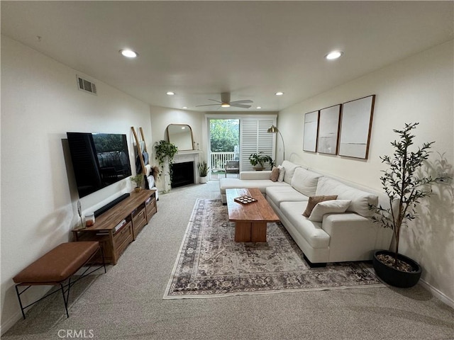 living room with light colored carpet and ceiling fan