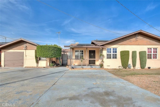 view of front of home with a garage and solar panels