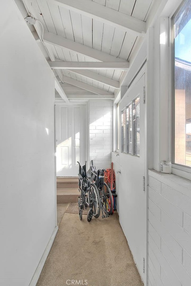 sunroom featuring lofted ceiling with beams and wood ceiling