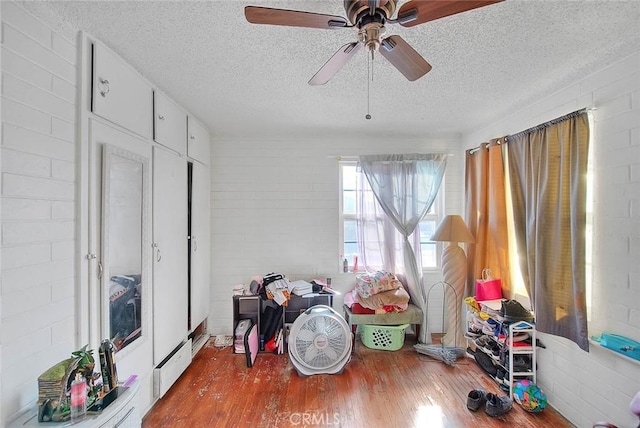 rec room with hardwood / wood-style floors and a textured ceiling