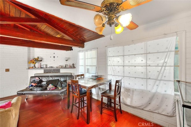 dining space with wood ceiling, brick wall, vaulted ceiling with beams, ceiling fan, and hardwood / wood-style floors