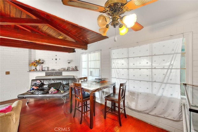 dining space with hardwood / wood-style flooring, ceiling fan, vaulted ceiling with beams, and wooden ceiling