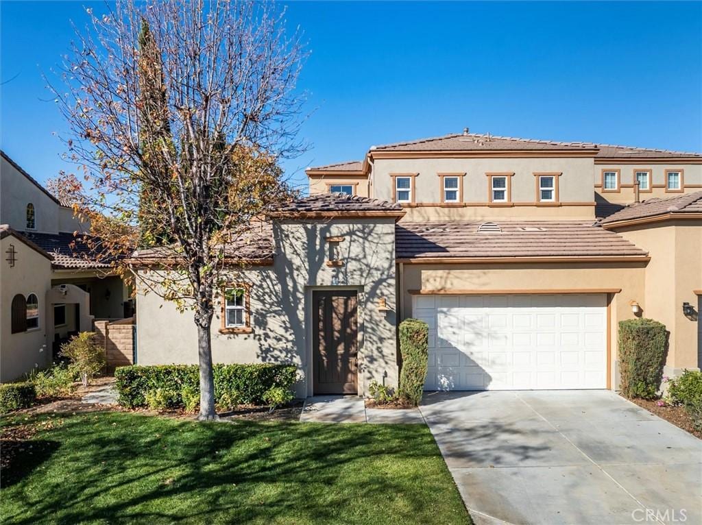 mediterranean / spanish-style home with a front lawn