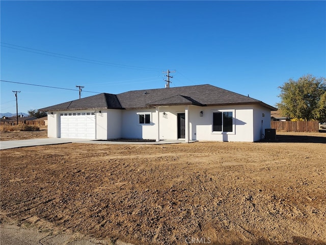 ranch-style house featuring a front lawn and a garage