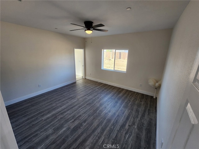 spare room with ceiling fan and dark hardwood / wood-style floors