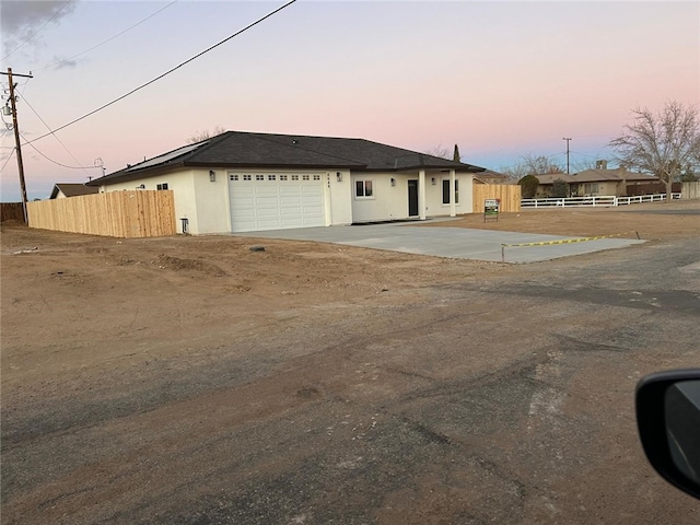 ranch-style home featuring a garage