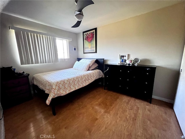 bedroom featuring hardwood / wood-style flooring and ceiling fan