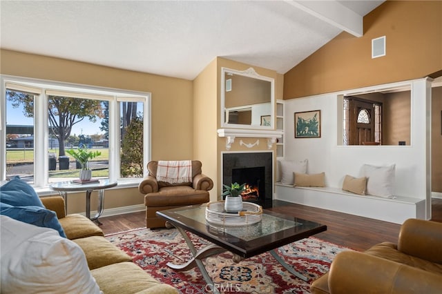 living room with hardwood / wood-style floors and lofted ceiling with beams