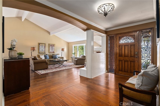 foyer entrance featuring vaulted ceiling with beams, dark wood-type flooring, and crown molding