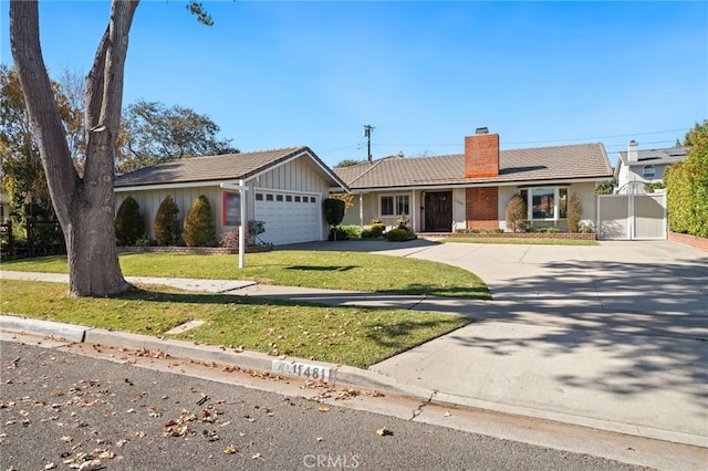 ranch-style home with a garage and a front lawn