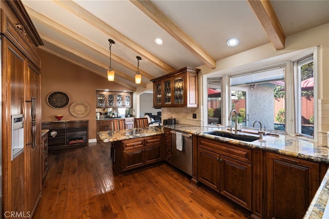 kitchen with sink, vaulted ceiling with beams, pendant lighting, dishwasher, and kitchen peninsula