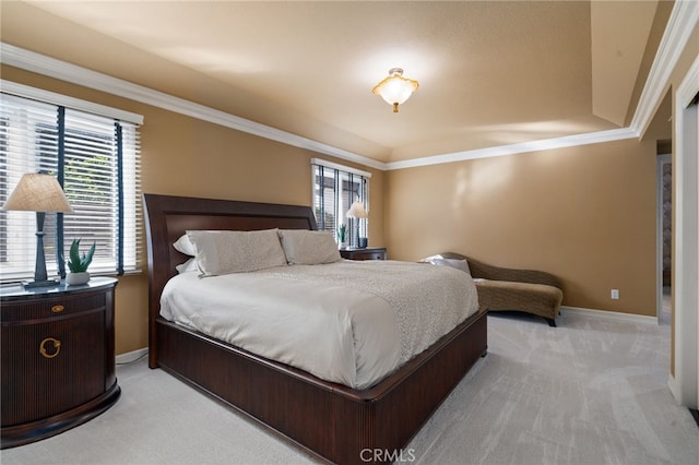 bedroom with ornamental molding and light carpet