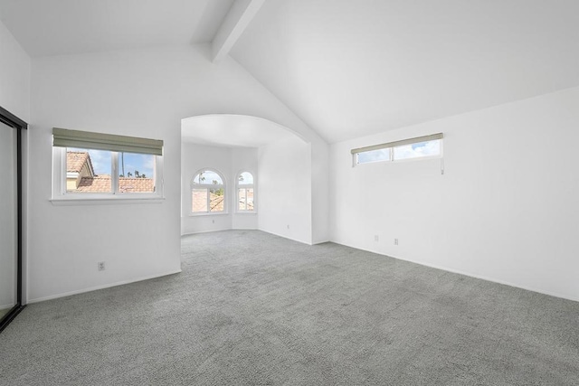 interior space featuring carpet flooring, beam ceiling, and high vaulted ceiling