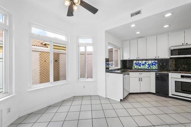 kitchen with decorative backsplash, ceiling fan, light tile patterned floors, dishwasher, and white cabinets