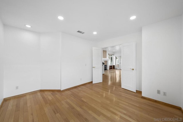 unfurnished room with hardwood / wood-style floors