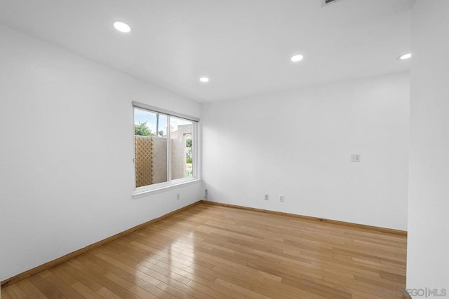 empty room with light hardwood / wood-style flooring