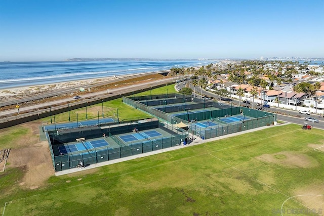 birds eye view of property featuring a water view and a beach view