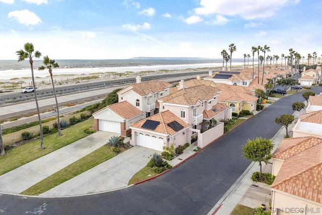 aerial view with a water view and a view of the beach