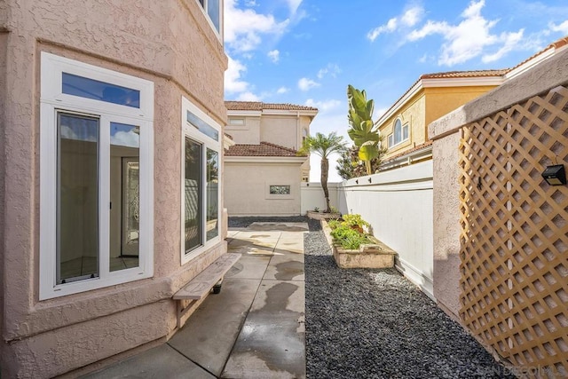 view of side of home with a patio