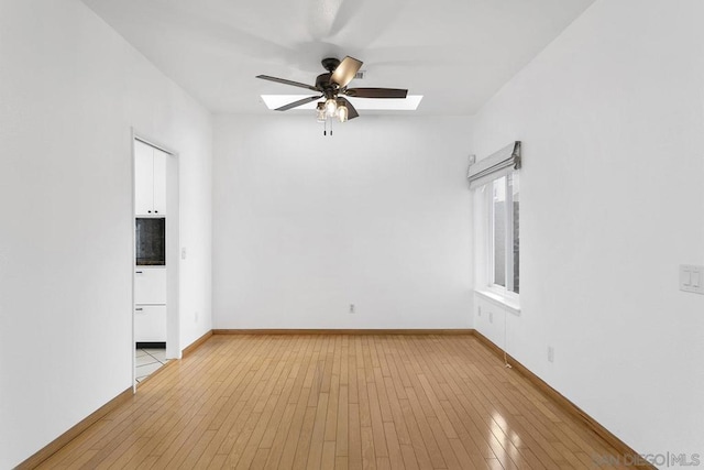 spare room featuring ceiling fan and light hardwood / wood-style flooring