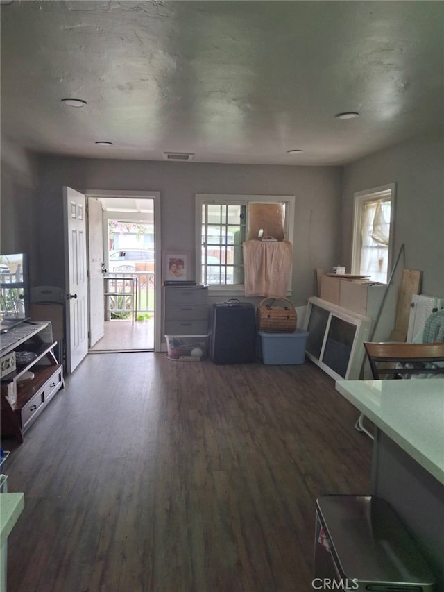 unfurnished living room with dark hardwood / wood-style flooring