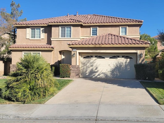 mediterranean / spanish-style home with a garage