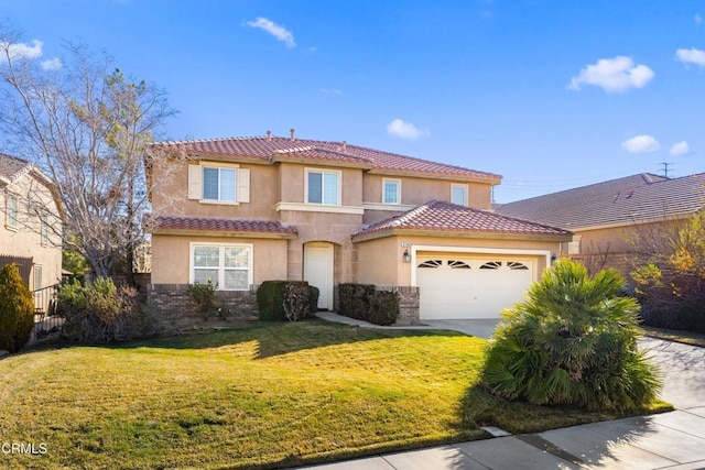 mediterranean / spanish-style house featuring a garage and a front lawn