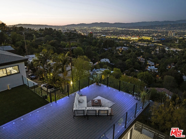 aerial view at dusk featuring a mountain view