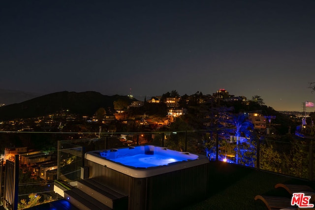 exterior space featuring an outdoor hot tub