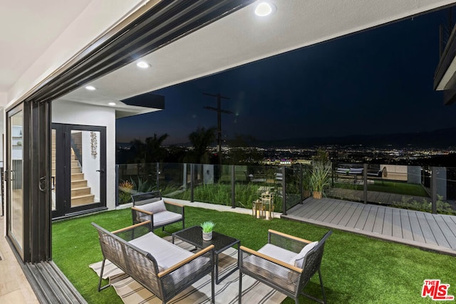 wooden terrace featuring outdoor lounge area and a lawn