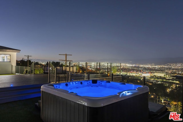 exterior space featuring a wooden deck and a hot tub