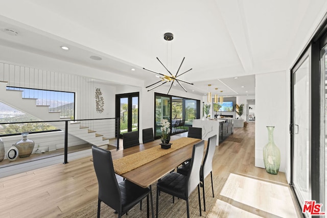 dining room featuring a notable chandelier and light wood-type flooring