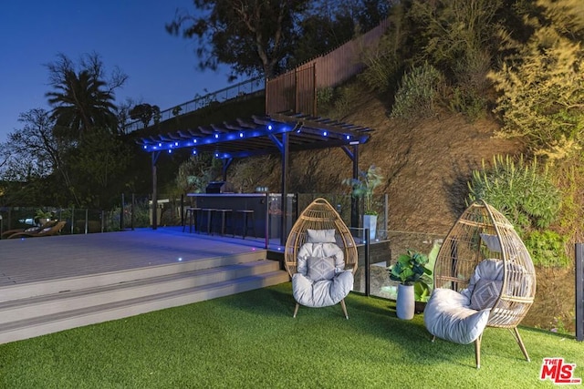 deck featuring an outdoor bar and a lawn