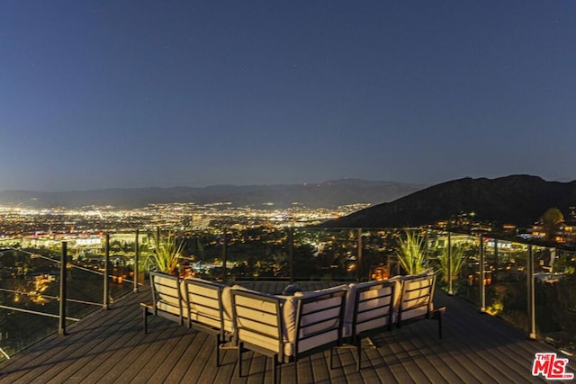 deck with an outdoor living space and a mountain view