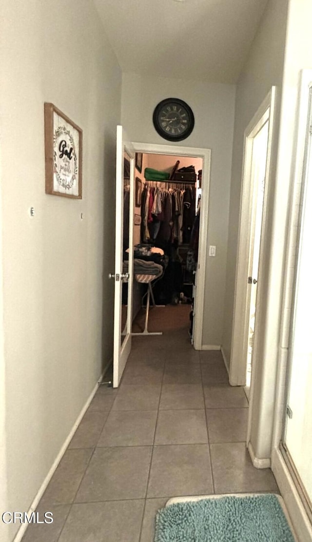 hallway with tile patterned flooring