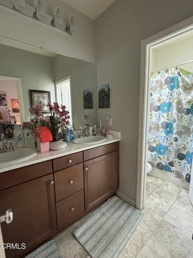 bathroom featuring vanity, toilet, and walk in shower