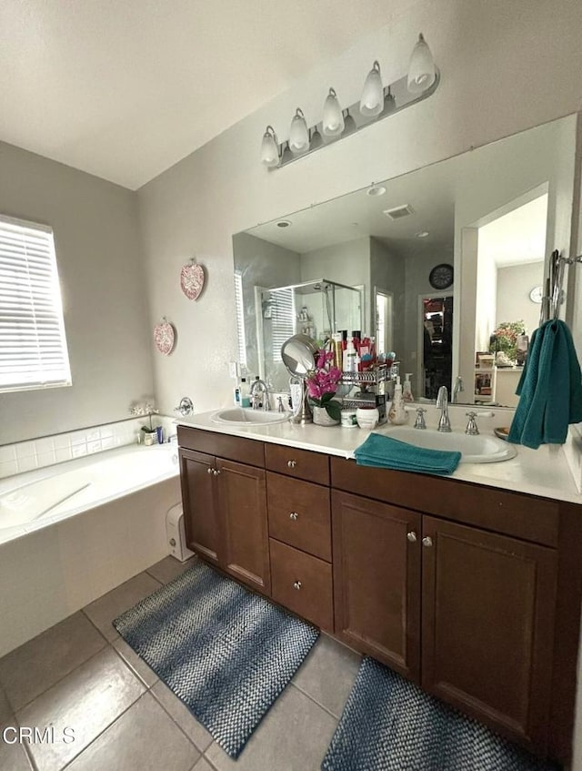 bathroom featuring tile patterned flooring, vanity, and plus walk in shower