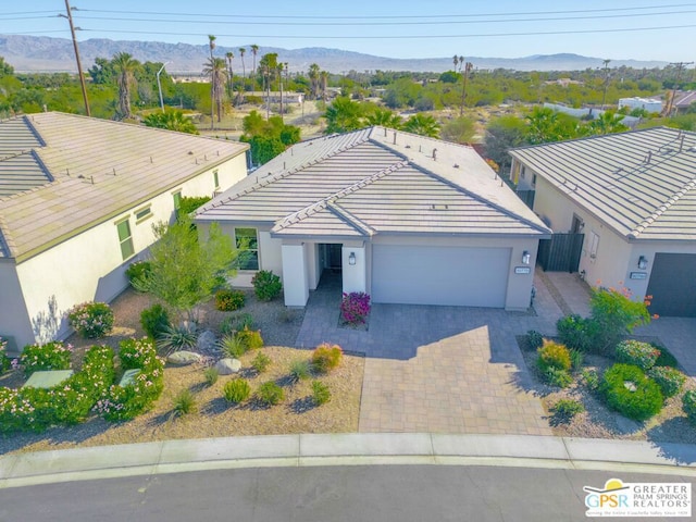 view of front of house with a mountain view and a garage