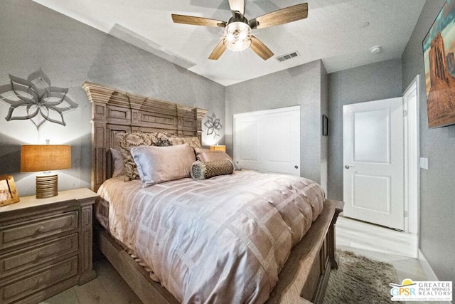 bedroom with light hardwood / wood-style floors and ceiling fan