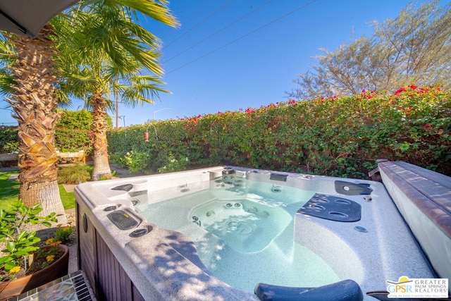 view of pool with a hot tub