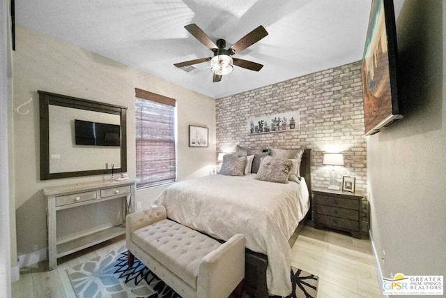 bedroom with ceiling fan and light hardwood / wood-style flooring