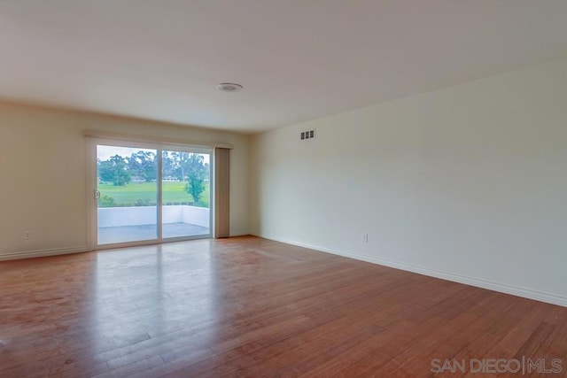 empty room with hardwood / wood-style floors