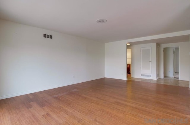 unfurnished room with light wood-type flooring