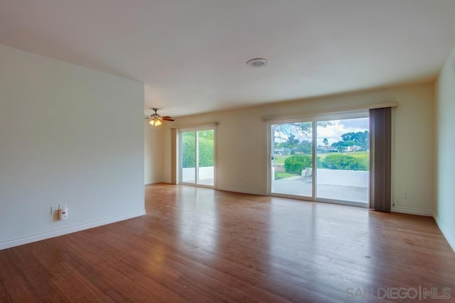 empty room featuring ceiling fan and light hardwood / wood-style floors