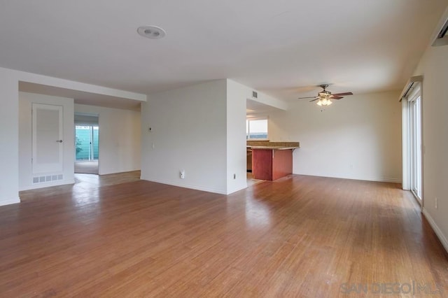 unfurnished living room featuring hardwood / wood-style flooring and ceiling fan