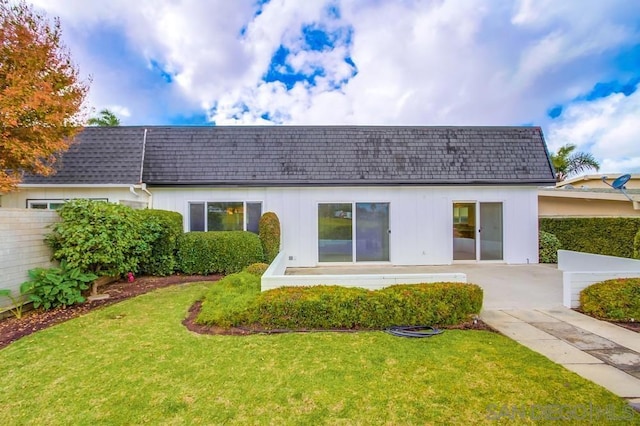 rear view of property with a yard